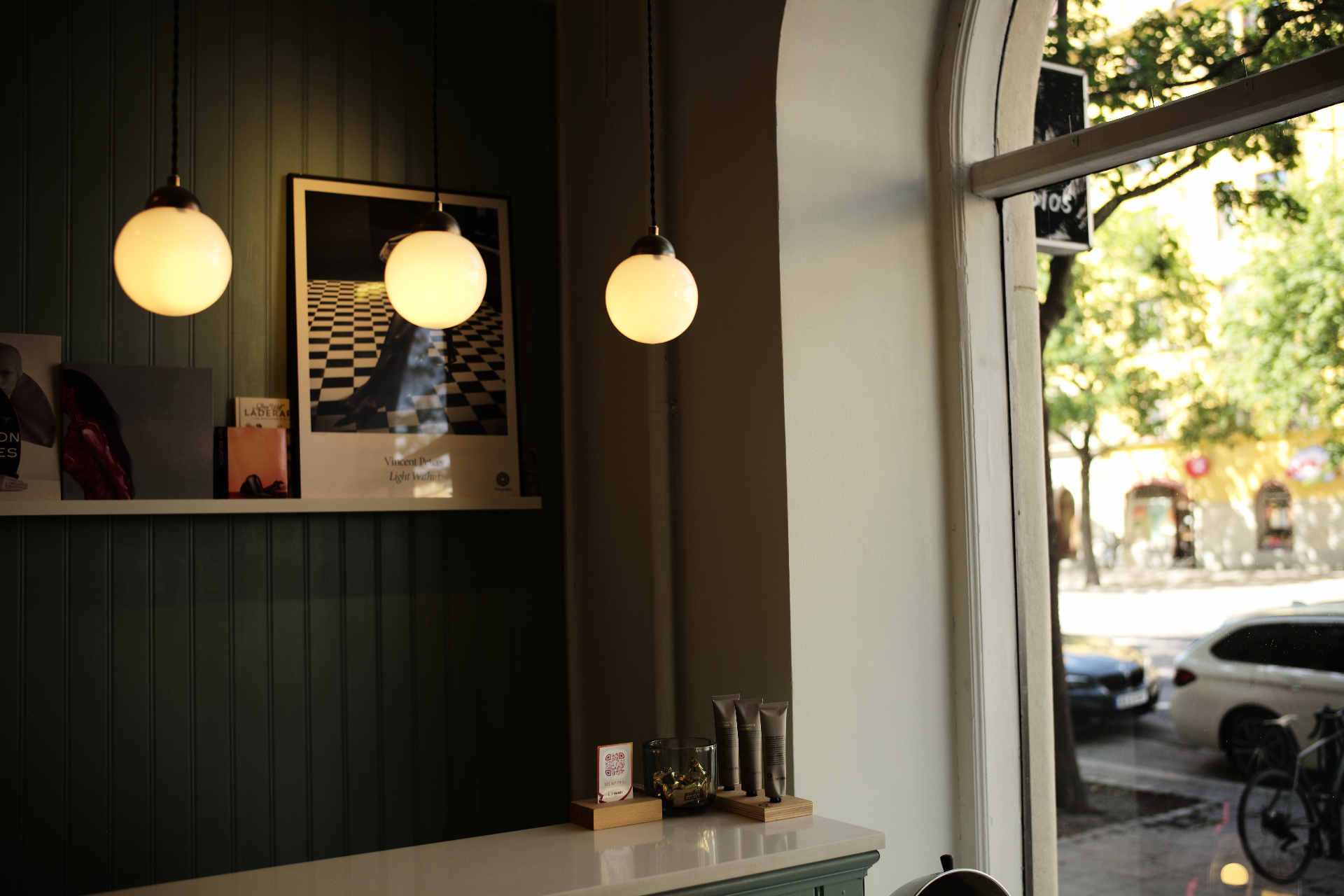Pendant lights glowing by the salon window